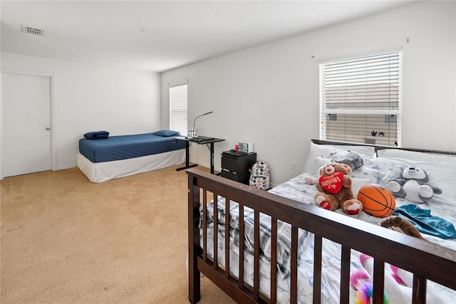 bedroom featuring light carpet