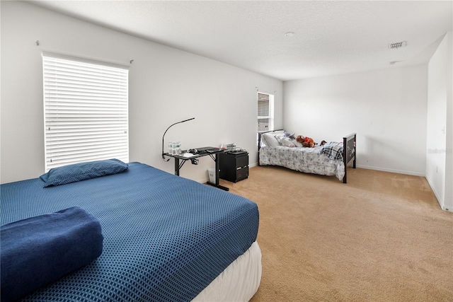 bedroom featuring a textured ceiling and carpet floors