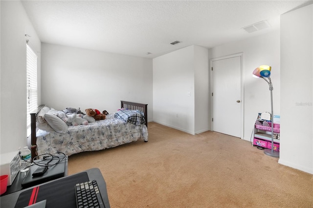 carpeted bedroom with a textured ceiling