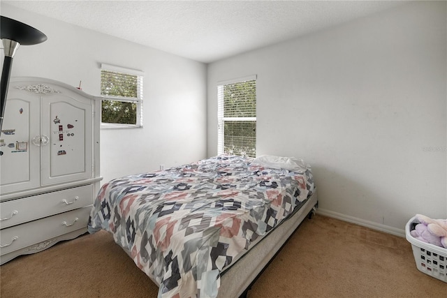 carpeted bedroom with a textured ceiling