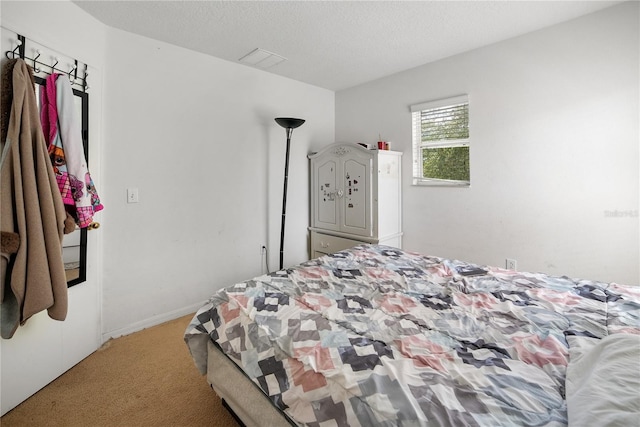 bedroom with a textured ceiling and carpet