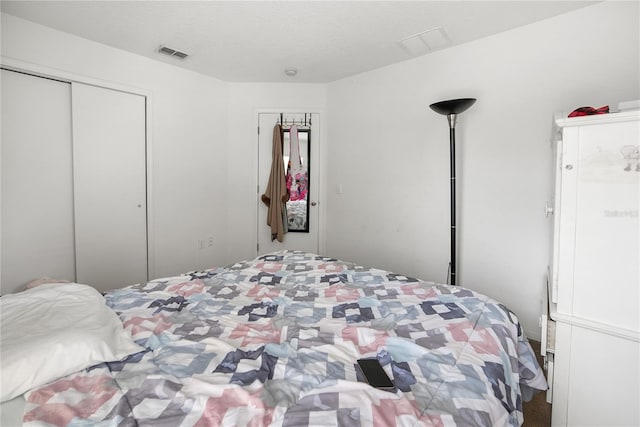 bedroom featuring a closet and visible vents