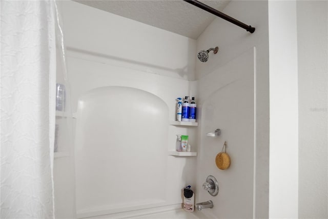details with shower / bath combination with curtain and a textured ceiling