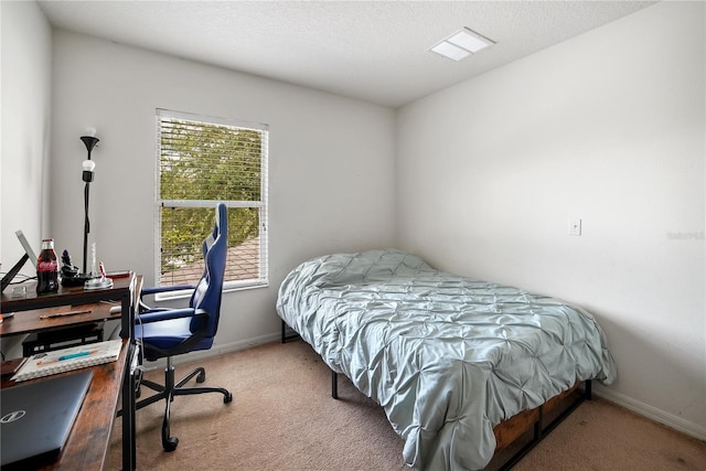 bedroom featuring a textured ceiling and carpet floors