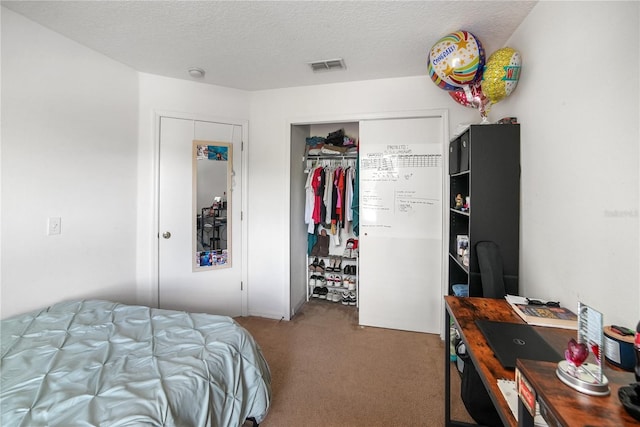 carpeted bedroom with visible vents, a closet, and a textured ceiling