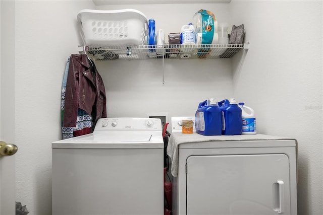 laundry area featuring washing machine and clothes dryer and laundry area