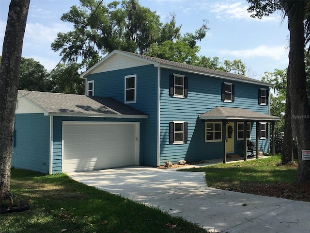 view of front of house with a garage and a front lawn