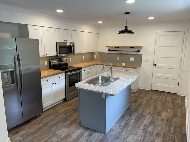 kitchen with dark wood-style flooring, stainless steel appliances, white cabinetry, a sink, and wood counters