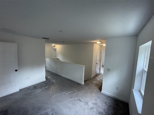 spare room with visible vents and baseboards