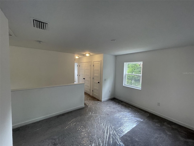 empty room with baseboards and visible vents