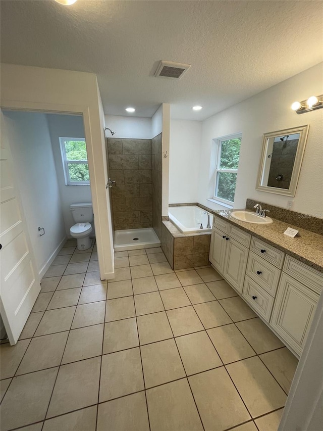 bathroom with tile patterned flooring, toilet, vanity, visible vents, and a shower stall