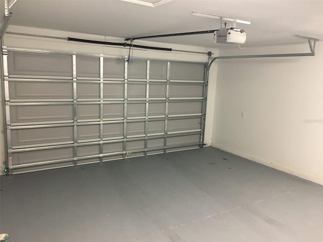 garage featuring baseboards and a garage door opener