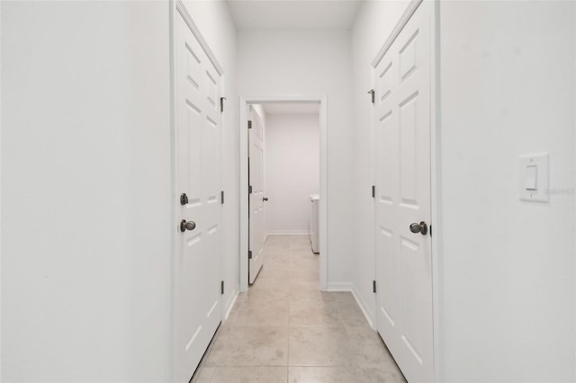 corridor featuring light tile patterned floors