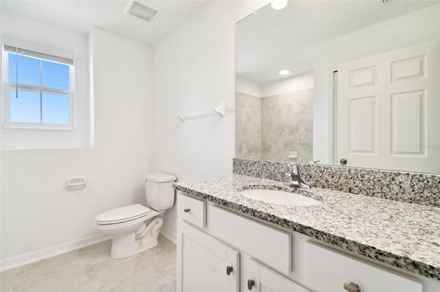 bathroom featuring tile patterned flooring, vanity, and toilet