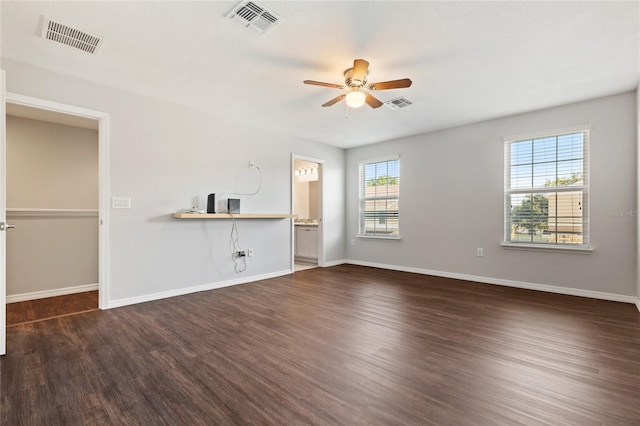 unfurnished living room featuring dark hardwood / wood-style flooring and ceiling fan