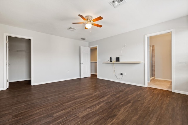 unfurnished bedroom with dark hardwood / wood-style flooring, ensuite bathroom, and ceiling fan