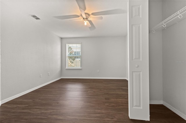 interior space with dark hardwood / wood-style flooring and ceiling fan