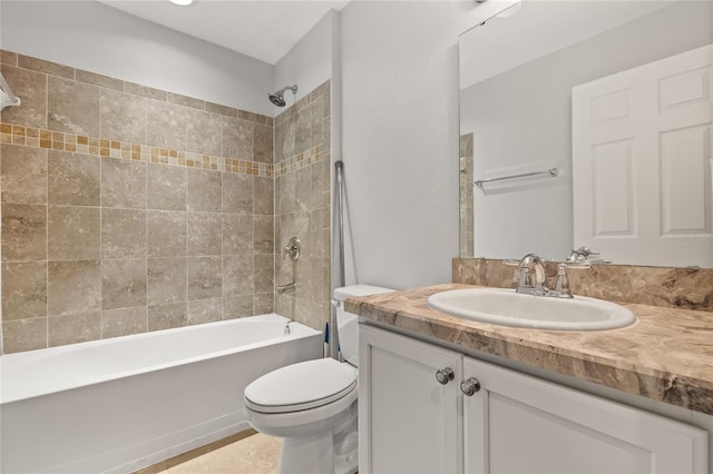 full bathroom with toilet, vanity, and tiled shower / bath