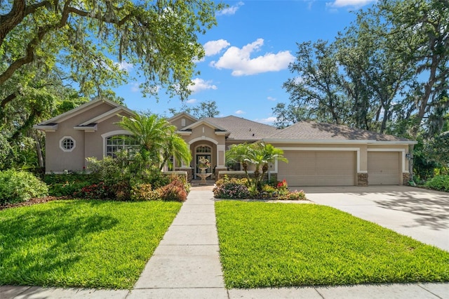 view of front of property featuring a front yard and a garage