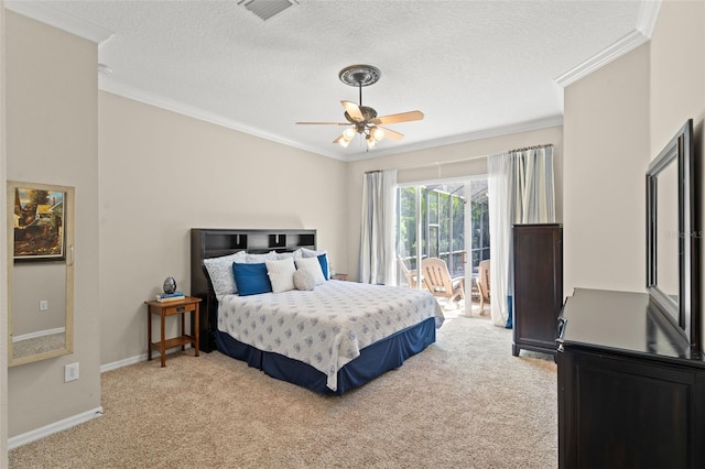 carpeted bedroom with ornamental molding, ceiling fan, and a textured ceiling