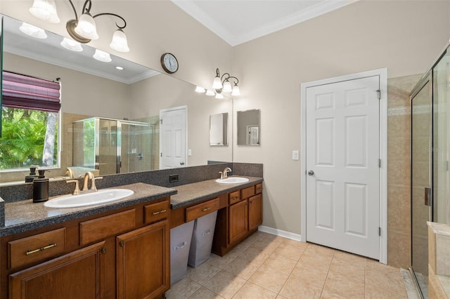 bathroom with tile flooring, large vanity, dual sinks, walk in shower, and ornamental molding