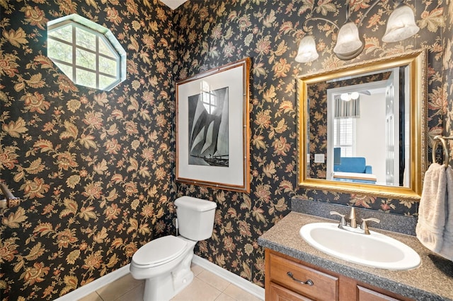 bathroom with tile flooring, vanity with extensive cabinet space, and toilet