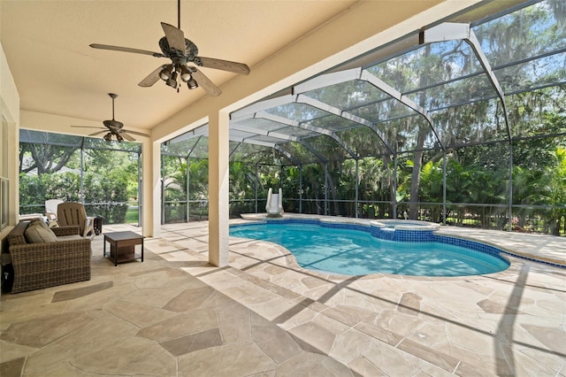 view of pool with a patio area, ceiling fan, an in ground hot tub, and a lanai