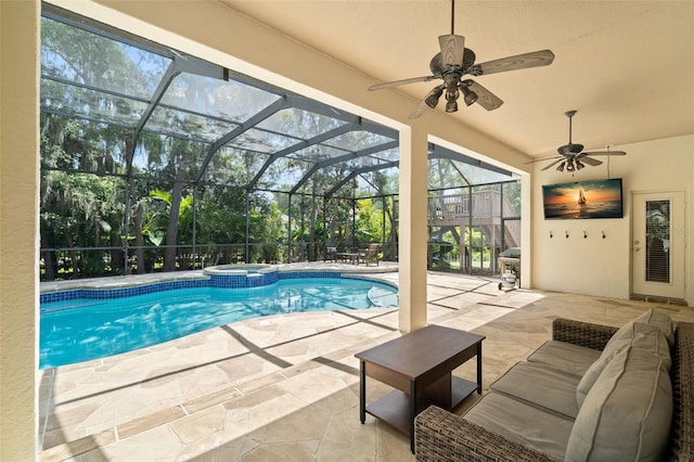 view of pool with a patio area, ceiling fan, outdoor lounge area, and glass enclosure