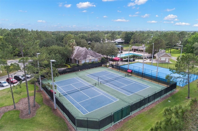 view of sport court featuring a covered pool