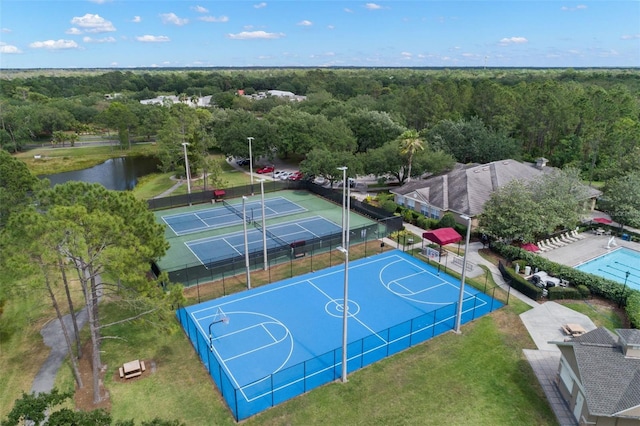 view of sport court with tennis court and a water view