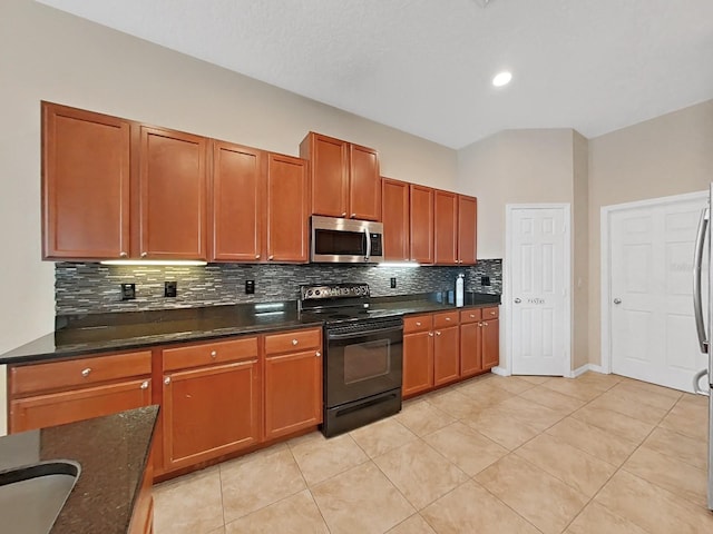 kitchen featuring black / electric stove, dark stone counters, tasteful backsplash, and light tile patterned floors