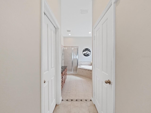 corridor featuring light tile patterned floors