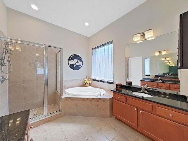 bathroom featuring vanity, independent shower and bath, and tile patterned flooring