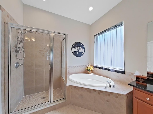 bathroom with vanity, tile patterned floors, and independent shower and bath