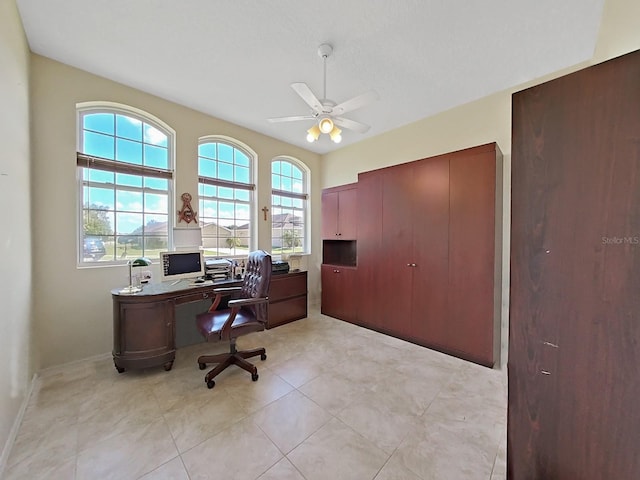 office area with a healthy amount of sunlight, light tile patterned floors, and ceiling fan