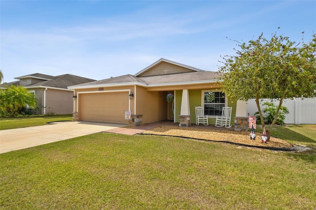 view of front of home with a front yard and a garage