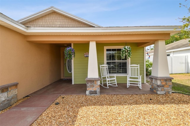 view of exterior entry with covered porch