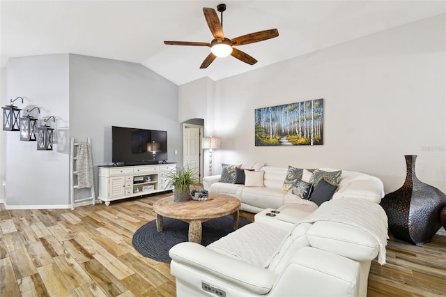 living room featuring light hardwood / wood-style flooring, ceiling fan, and vaulted ceiling