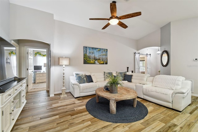 living room with high vaulted ceiling, light hardwood / wood-style flooring, and ceiling fan