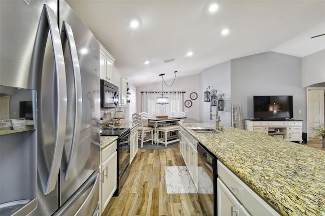 kitchen featuring hanging light fixtures, light hardwood / wood-style flooring, black appliances, white cabinets, and sink