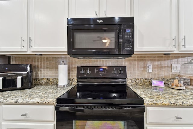 kitchen with backsplash, white cabinetry, black appliances, and light stone countertops