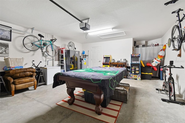 game room featuring a textured ceiling, electric water heater, concrete floors, and pool table