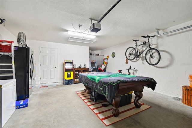 game room featuring pool table, concrete floors, and a textured ceiling