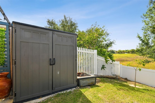 view of shed / structure with a lawn