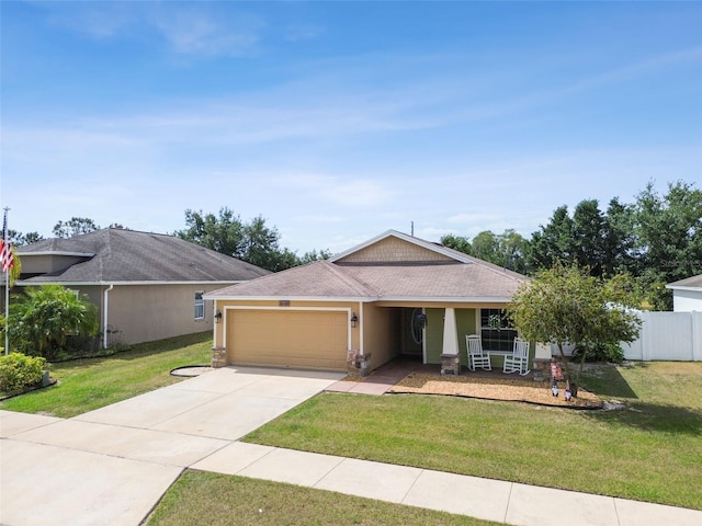 ranch-style home with a front yard and a garage