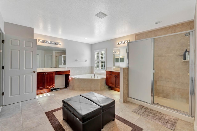 bathroom with tile patterned floors, vanity, and shower with separate bathtub