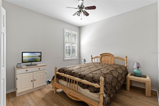 bedroom featuring ceiling fan and light hardwood / wood-style flooring