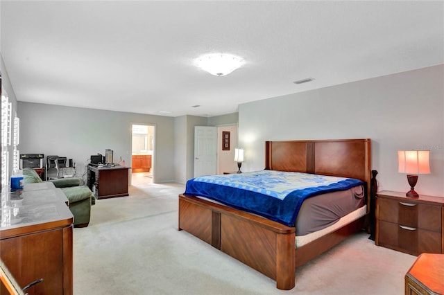 carpeted bedroom with ensuite bathroom