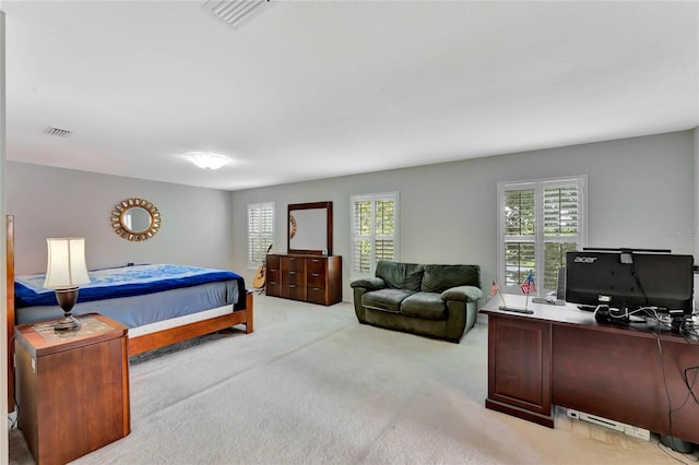 bedroom featuring light carpet