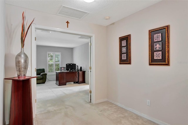 hall featuring light colored carpet